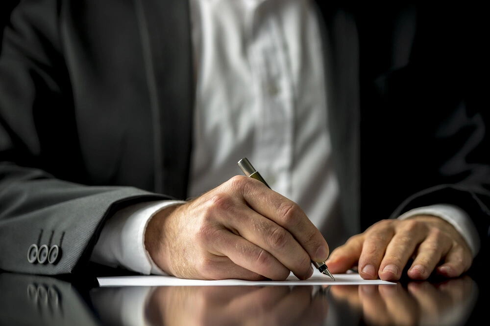 Lawyer signing a document